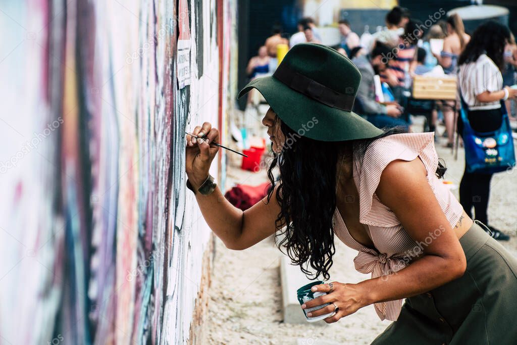 Woman painting on a wall