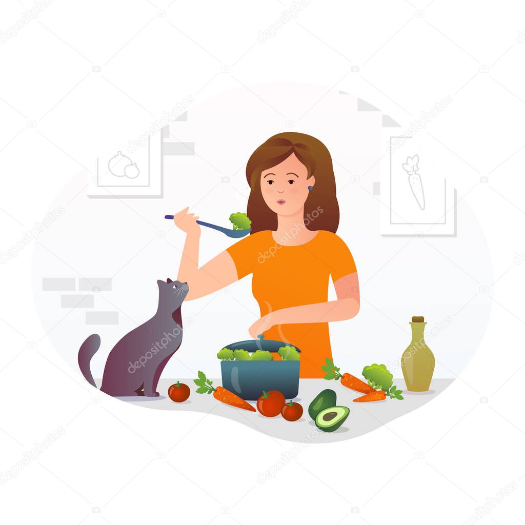 Girl cooks in the kitchen with a cat