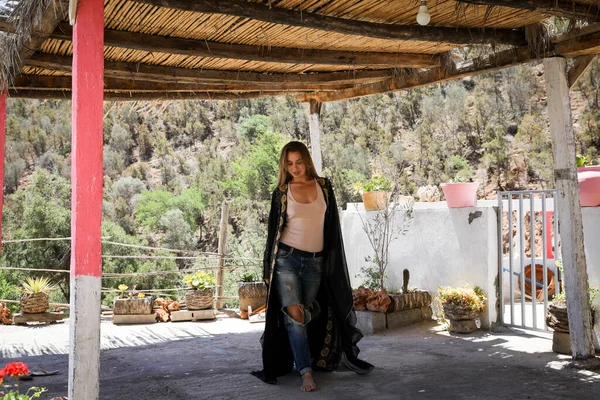 A girl in an arabic cape in nature. Paradise Valley Agadir Morocco.