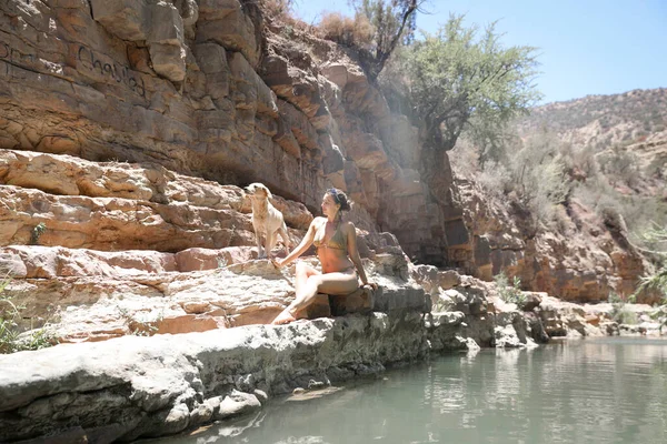 一个穿着泳衣的女孩坐在河边的悬崖上 天堂谷Agadir摩洛哥 — 图库照片