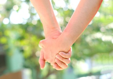 Erkek ve kadın birbirlerine bakmak ve yardım etmek için el ele tutuşuyorlar. Aile ve Sevgililer Günü konsepti.