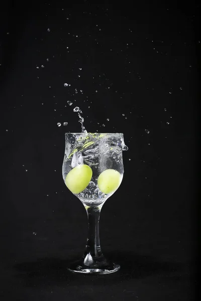 Water Splash Out Glass Black Background Green Grapes Royalty Free Stock Images