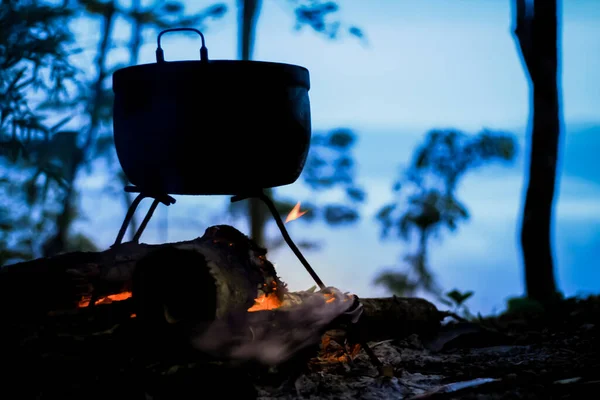 cooking on campfire in wild camping on mountain