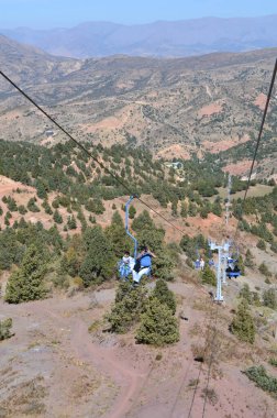İnsanlar teleferiğe dağa tırmanıyor. Güneşli bir yaz gününde. Özbekistan Dağları, Beldersay