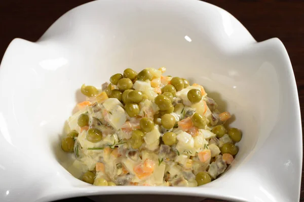 Olivier salad served in a restaurant, close up. Photos for restaurant and cafe menus