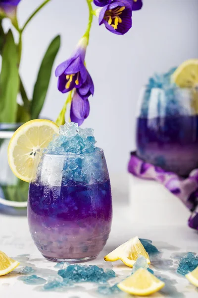 Butterfly pea flower blue ice lemonade with lemon and coconut syrup