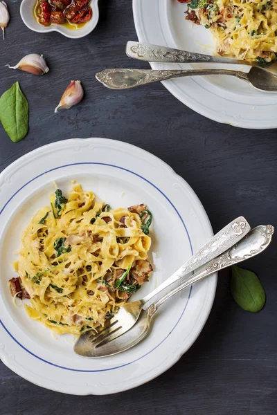 Italian pasta sweet potato tagliatelle with bacon, sun-dried tomatoes and spinach