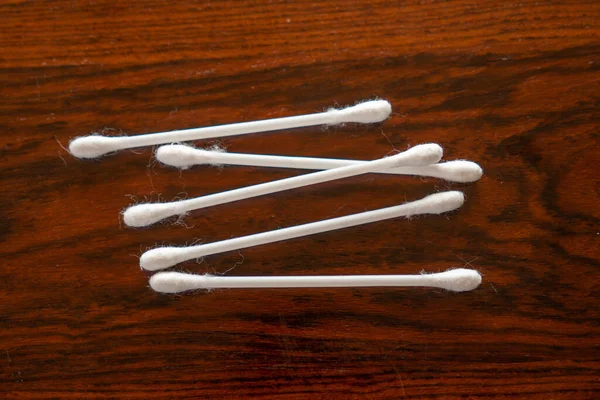 Some cotton swabs in a wooden table