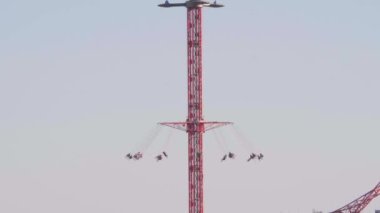 Güneşli bir günde açık gökyüzü ile koşan Star Flyer adlı Madrid eğlence parkının cazibesi.