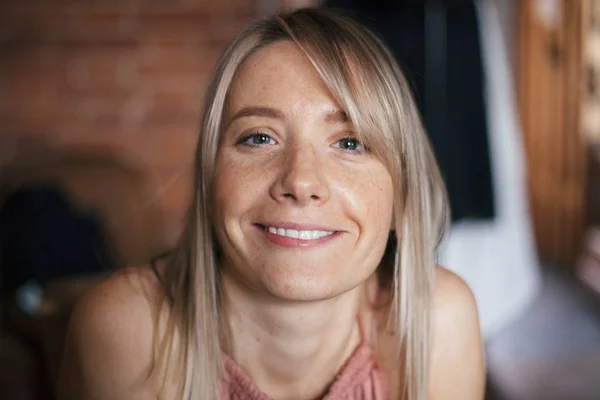 Primer plano retrato cálido natural de una hermosa sonriente joven rubia feliz con manchas solares. Girl está dentro. Estilo de vida —  Fotos de Stock