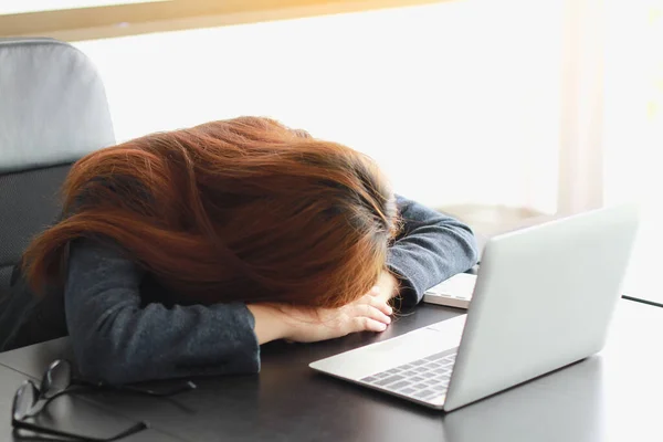 stressed businessman sleep on his laptop with burnout syndrome