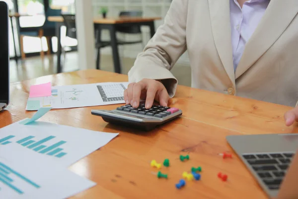 Businessman using office annual balance display calculator.accounting concept.