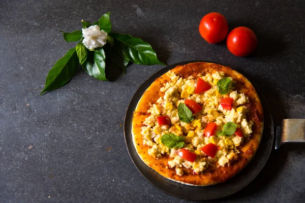 Indian Style Pizza Cottage Cheese Tomatoes Black Background Flower Leaves — Stock Photo, Image
