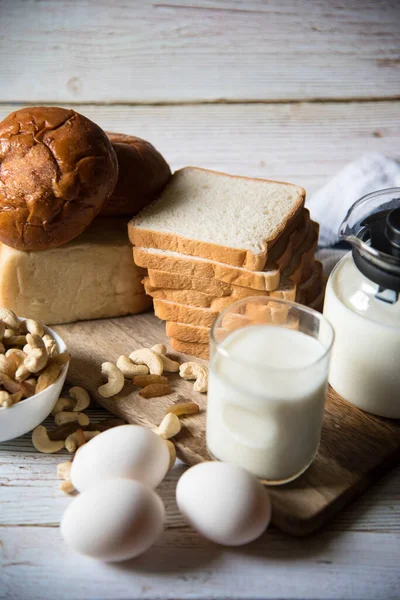 Healthy breakfast menu comprising of milk, eggs, nuts and bread with use of selective focus