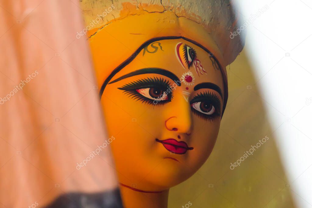 Close up of unfinished clay idol of Goddess Durga with use of selective focus