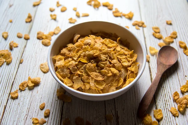 Close up of corn flakes in a bowl on a background with use of selective focus.