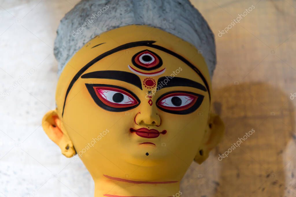 Colorful face of Hindu Goddess Durga with use of selective focus.