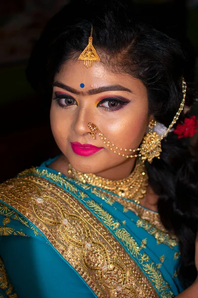 an indian teenage girl happy with indian ethnic wear and ornaments in a marriage reception party