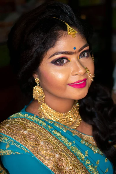 an indian teenage girl happy with indian ethnic wear and ornaments in a marriage reception party