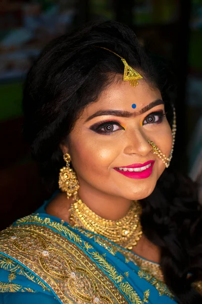 an indian teenage girl happy with indian ethnic wear and ornaments in a marriage reception party