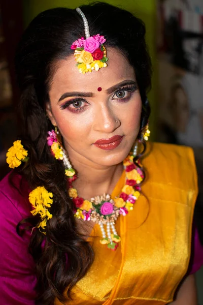 an indian woman wearing traditional dress and flower ornaments