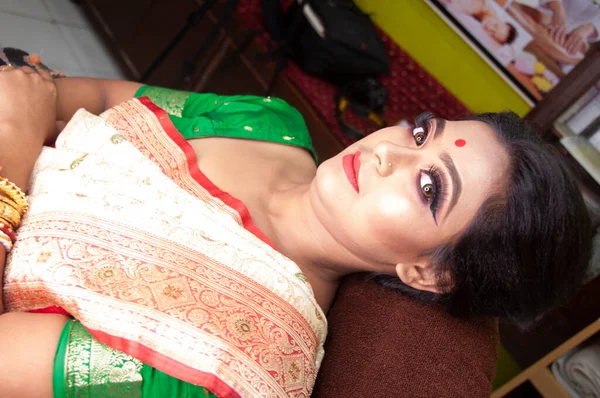 Hintli bir kadın gelin makyajı yaptırıyor.