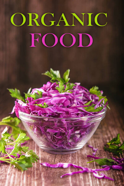 Shredded red cabbage with parsley in a transparent bowl on a dark wooden background, Vegetarian healthy food, organic food