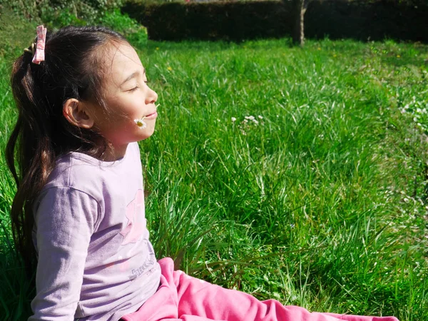 Relaxed Little Girl Sitting Grass Sunshine Holding Flower His Mouth — Stock Photo, Image