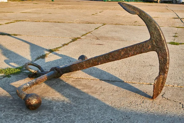 Old rusty two-legged anchor in the seaport Anapa