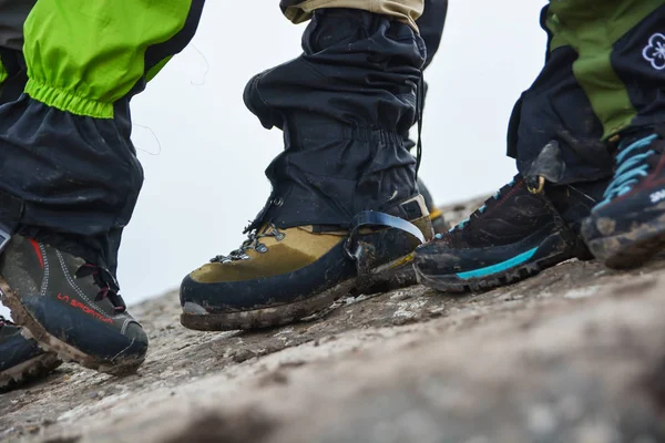 Vista lateral dos pés usando sapatos de caminhada com pedra no fundo . — Fotografia de Stock