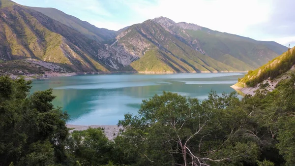 Beautiful mountain turquoise color lake Karasuu in Tian-Shan, Kyrgyzstan. Arial view. Soft focus. Blurred.