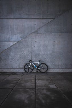 Gri beton duvarda beyaz bisiklet