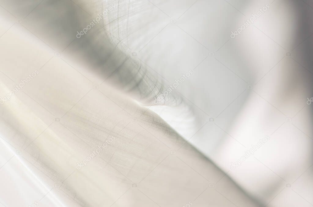 Abstract photograph of light fabric waving in spring breeze