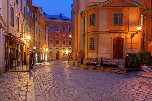 Old medieval street in the night illumination on the island Gamla Stan. Stockholm. Sweden.