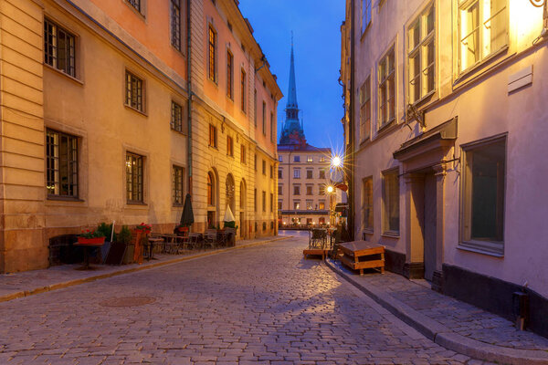 Old medieval street in the night illumination on the island Gamla Stan. Stockholm. Sweden.