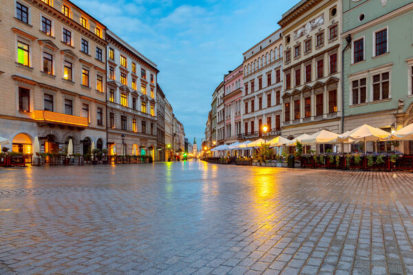 View of the old market square in the light of lanterns at sunrise. Krakow. Poland.