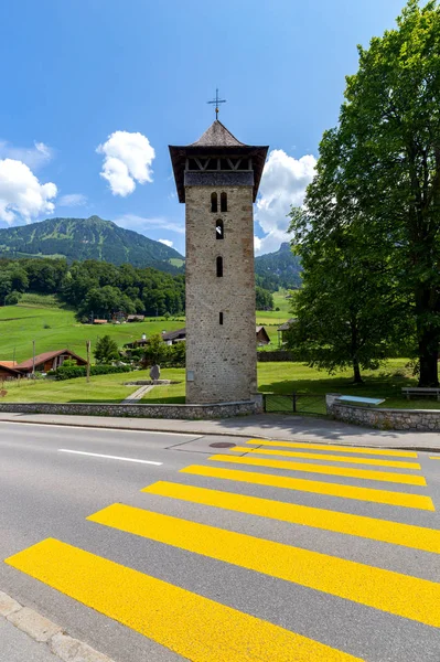 Lungern. Old stone bell tower in a swiss village. — Stock Photo, Image