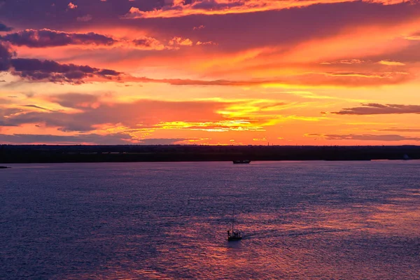 Silhouette of man in a boat on a river at sunset Royalty Free Stock Images