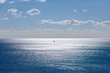 Tek bir yat açık denizde seyrediyor.