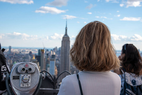 Tourist looking at the Empire State one of the most iconic buildings in NYC