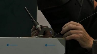 Metal parçaları kaynaştıran işçilerin yakın çekim görüntüleri.