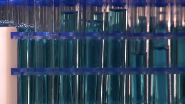 Test Tubes Blue Liquid Rotating Black Background Laboratory — Stock Video