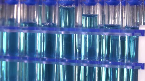 Test Tubes Blue Liquid Rotating Black Background Laboratory — Stock Video