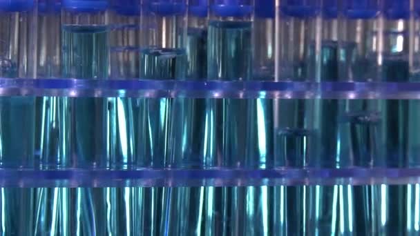 Test Tubes Blue Liquid Rotating Black Background Laboratory — Stock Video