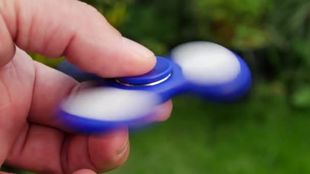 Hand Holding Popular Fidget Spinner Toy Sky Background — Stock Video