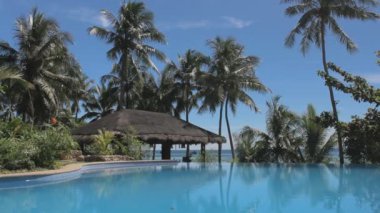 Güneşli yaz gününde güzel bir otel havuzu manzarası.