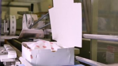 Fabrikada kutularca tatlı hamur işi taşıyan taşıyıcının yakın çekim görüntüleri.