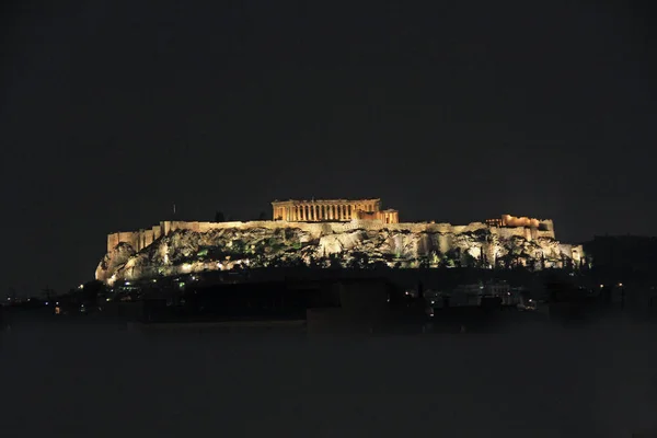 Looking up at the Parthenon above the support wall on the Acropolis in Athens, Greece with a black night  sky copy space and no people.