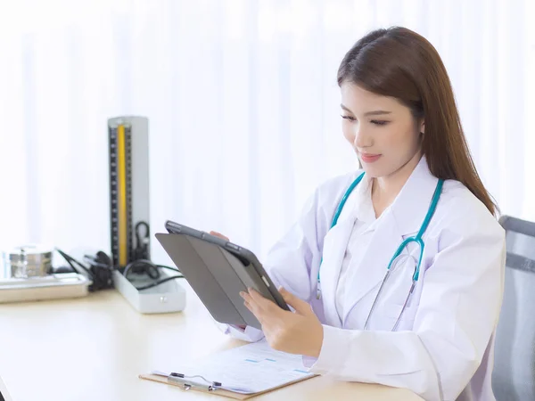 Asyalı Kadın Doktor Tabletteki Hastasının Raporunu Hazırlıyor Hastanedeki Masada Bir — Stok fotoğraf