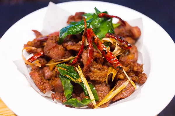 Deep fried sun dried pork is a appetizer in Thai food. It is a strip of pork mixed with Thai herb and sun dried until its semi dried and fried it.